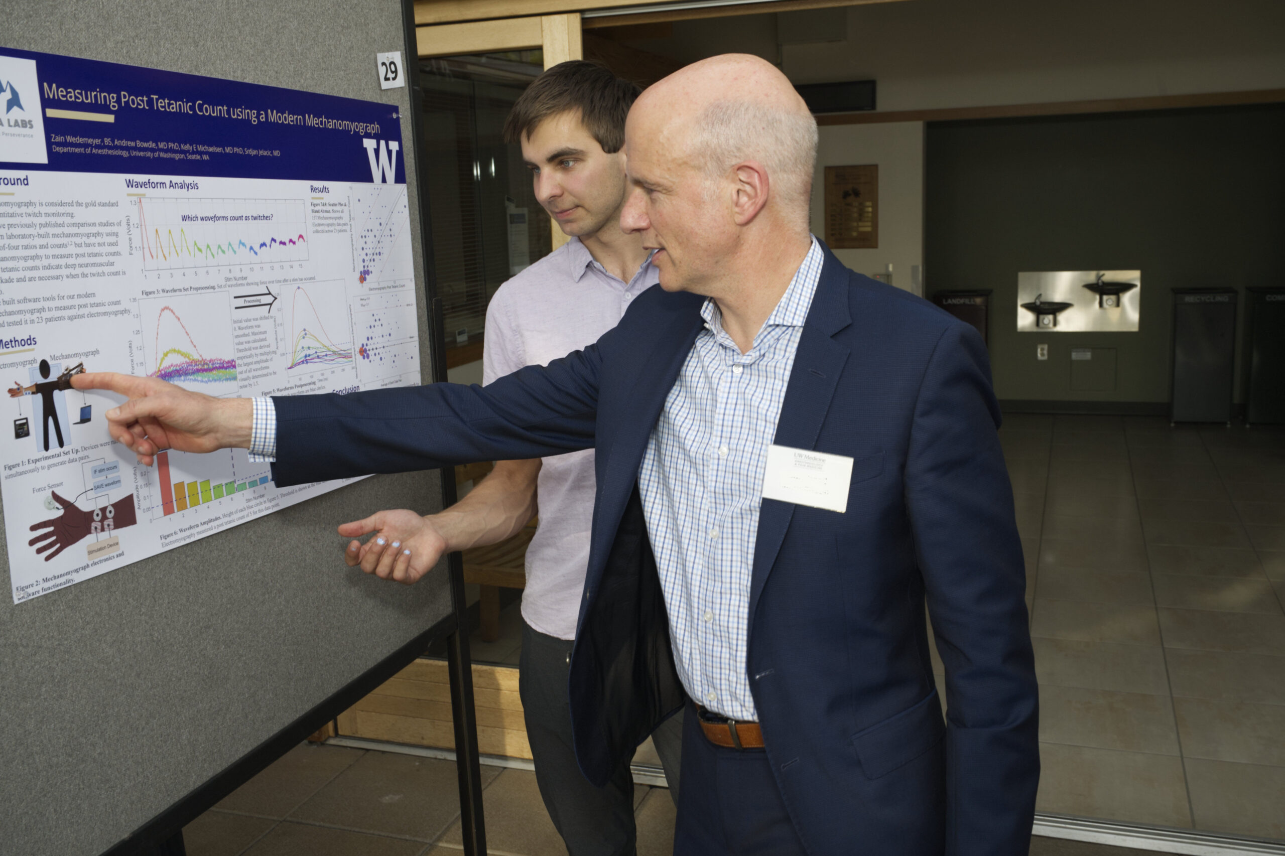 Dr. Mackensen pointing to a science poster