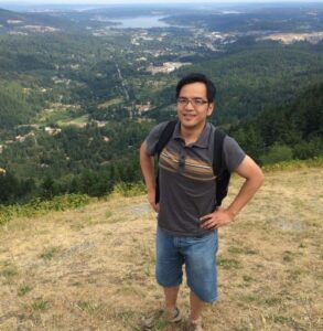 Dr. Li Li standing on hill looking out at Puget Sound 