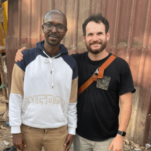 Drs. Daher and Tischer, smiling and standing close to each other in front of a building.