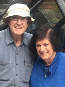 Dr. Fred Cheney and Pi Cheney, enjoying retirement. Dr. Cheney is wearing a bucket hat, they are both smiling.