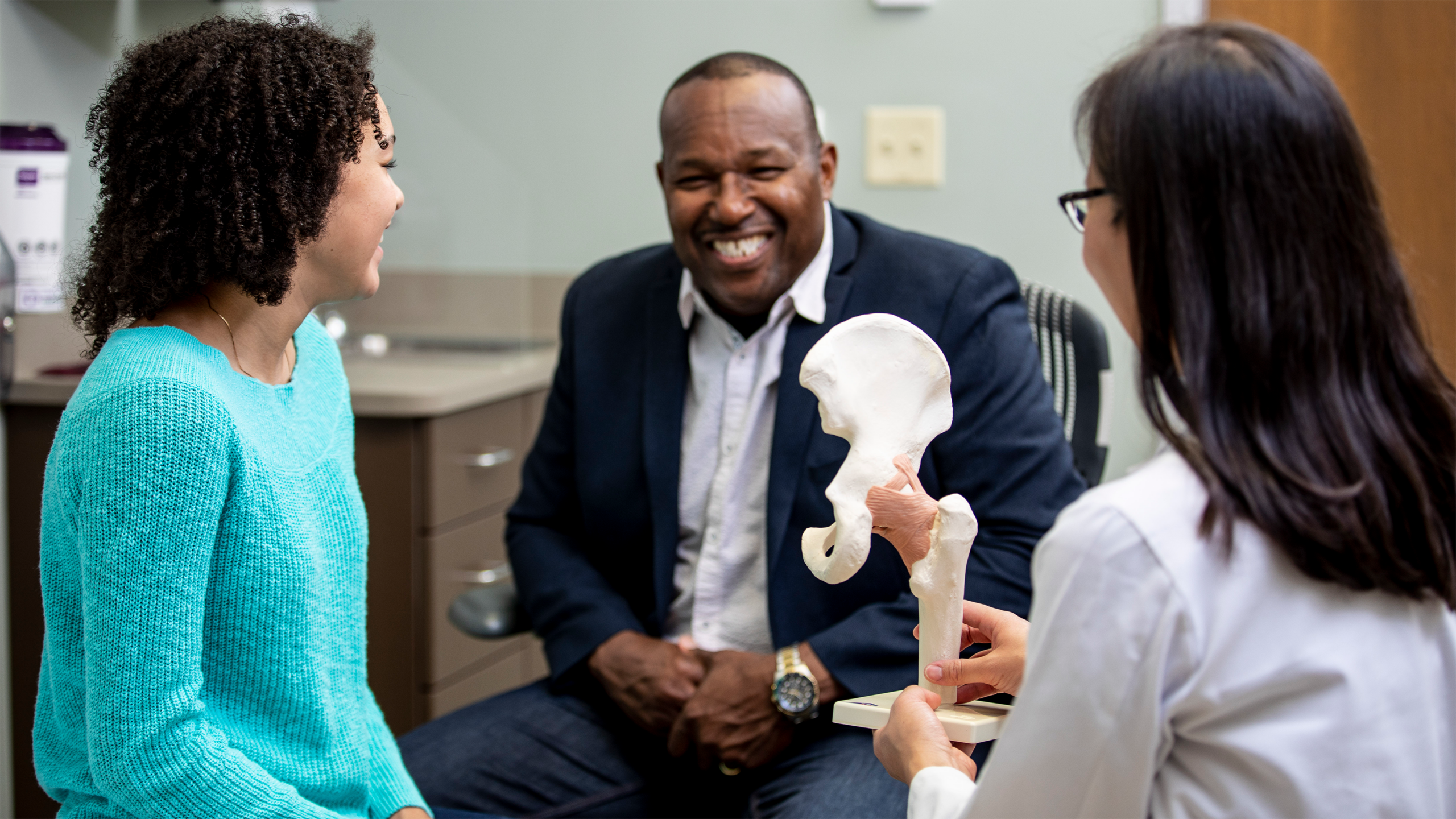 family members speak with a physician in a doctor's office.