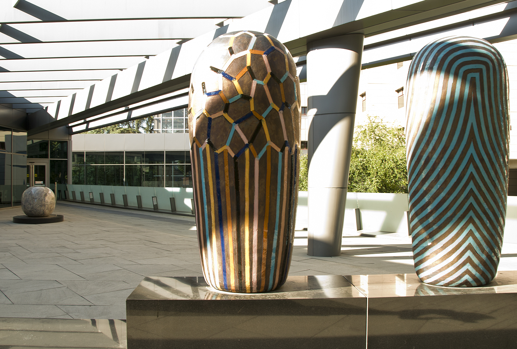 A picture of two sculptures at the entrance of a hospital.